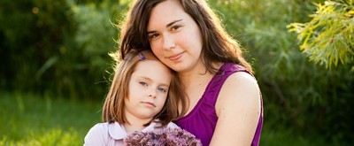 Mother and daughter sitting in a park