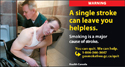 Man paralyzed by a stroke getting assistance in the bathroom by a male attendant.