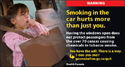 A little girl coughing inside a vehicle because of tobacco smoke.
